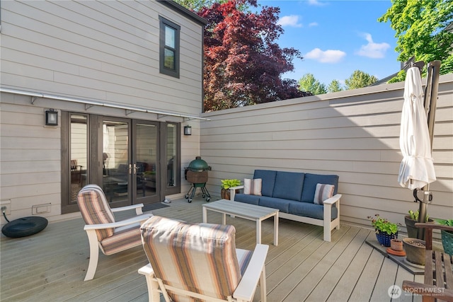 wooden deck with outdoor lounge area and french doors