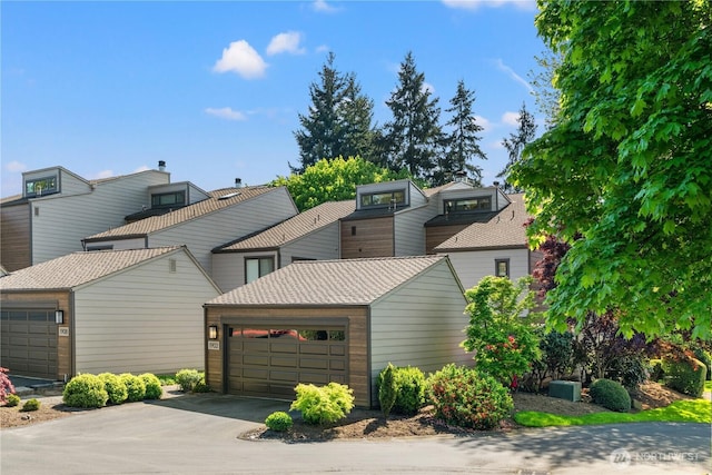 view of front of property featuring a garage and aphalt driveway