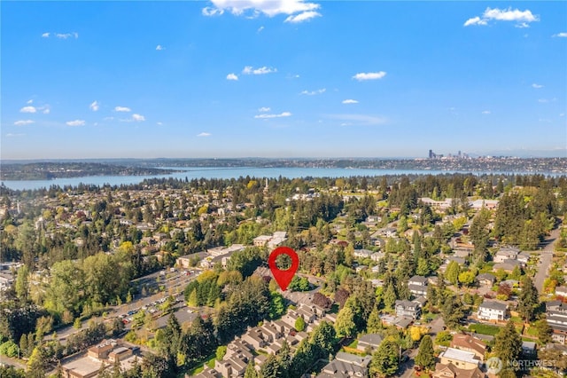 birds eye view of property with a water view and a residential view