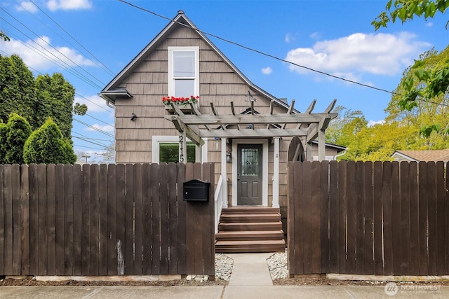 view of front of home featuring fence