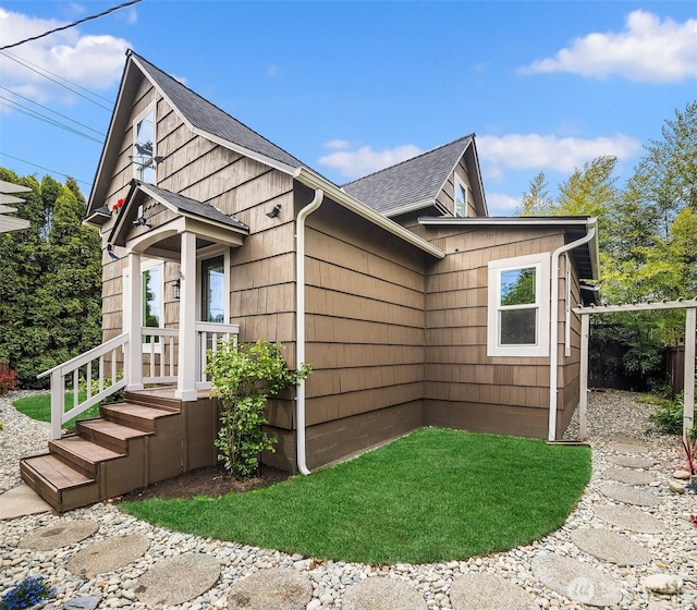 view of home's exterior featuring roof with shingles
