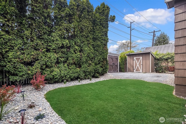 view of grassy yard with a shed and an outdoor structure