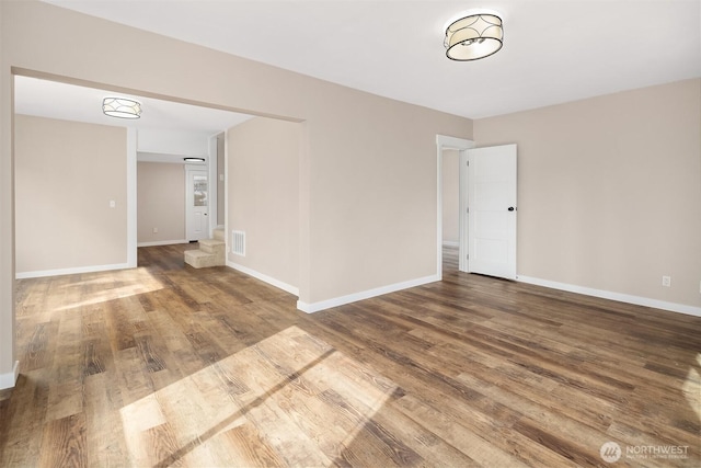 spare room featuring wood finished floors and baseboards