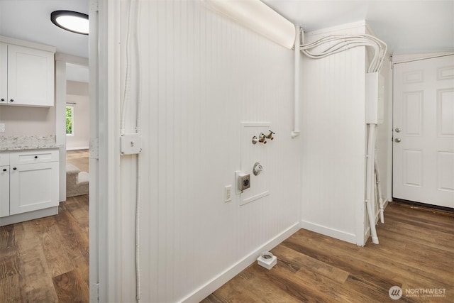 washroom featuring hookup for an electric dryer, dark wood-style floors, baseboards, and electric panel