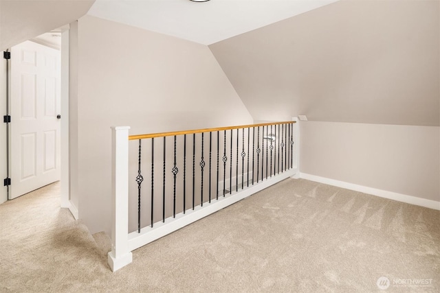 bonus room with carpet flooring, vaulted ceiling, and baseboards