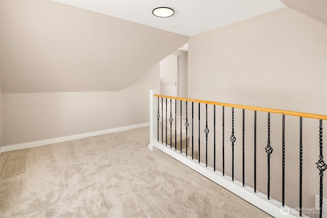 additional living space featuring vaulted ceiling, carpet, and baseboards