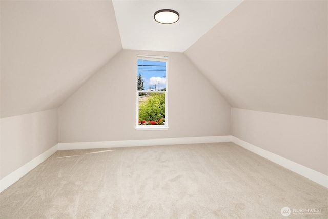 bonus room featuring carpet, vaulted ceiling, and baseboards