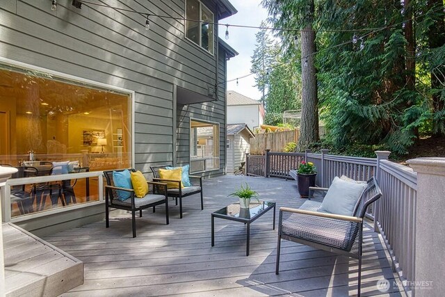wooden terrace featuring an outdoor living space