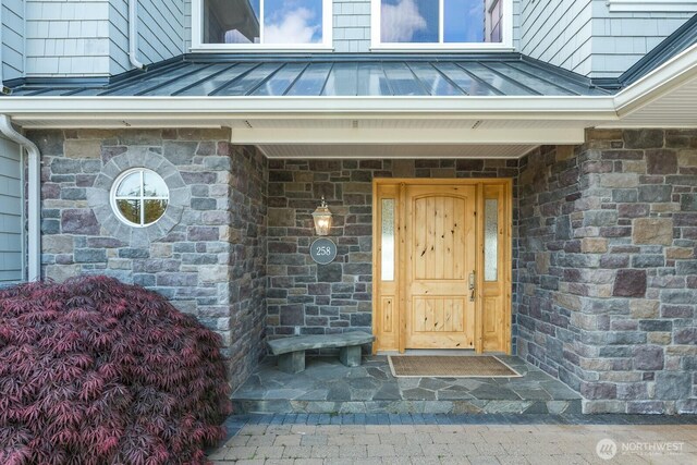 doorway to property featuring a standing seam roof and metal roof