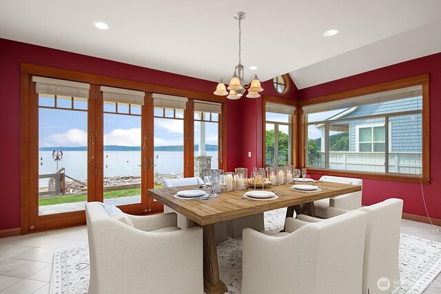 dining room with a chandelier, a water view, lofted ceiling, baseboards, and recessed lighting