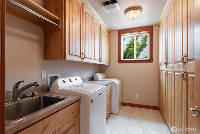 laundry area featuring cabinet space, separate washer and dryer, light tile patterned floors, and baseboards