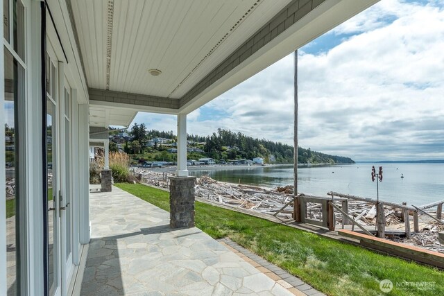 view of patio with a water view