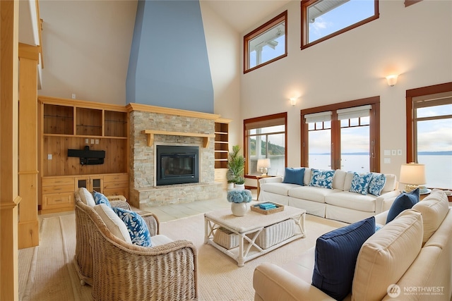 258 Gough Rd, Camano Island, WA 98282 - living area featuring a high ceiling, a fireplace, and plenty of natural light