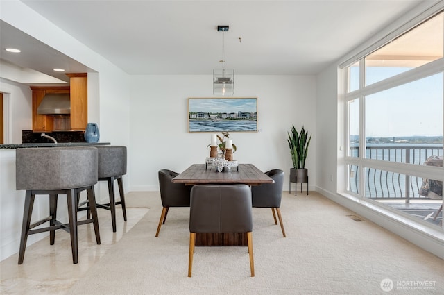2015 SE Columbia River Dr Unit 320, Vancouver, WA 98661 - dining room featuring light carpet, a water view, baseboards, and recessed lighting