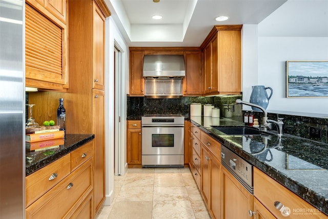 2015 SE Columbia River Dr Unit 320, Vancouver, WA 98661 - kitchen featuring a sink, dark stone counters, wall chimney exhaust hood, backsplash, and range