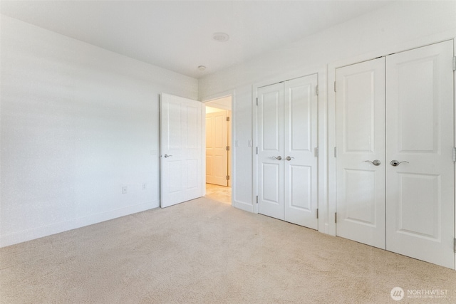 2015 SE Columbia River Dr Unit 320, Vancouver, WA 98661 - unfurnished bedroom with baseboards, multiple closets, and carpet floors