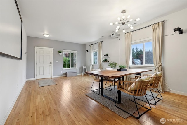 27859 256th Ct SE, Maple Valley, WA 98038 - dining room featuring light wood finished floors, a chandelier, and baseboards