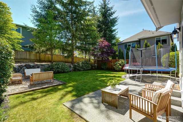 view of yard with a trampoline, an outdoor hangout area, and a patio area