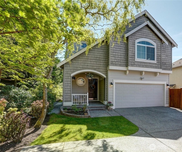 view of front of home featuring driveway, a garage, and a porch