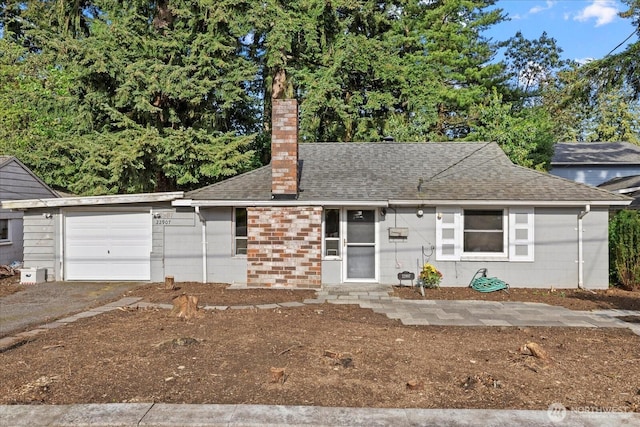 22907 60th Ave W, Mountlake Terrace, WA 98043 - view of front of home featuring an attached garage, a chimney, roof with shingles, and driveway