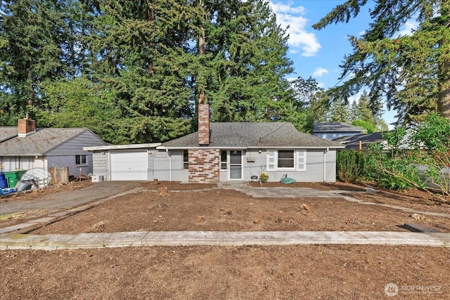 22907 60th Ave W, Mountlake Terrace, WA 98043 - view of front facade with a garage, driveway, and a chimney