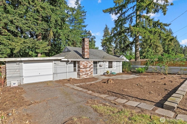 22907 60th Ave W, Mountlake Terrace, WA 98043 - view of front facade featuring an attached garage, a chimney, driveway, brick siding, and a shingled roof