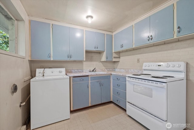 22907 60th Ave W, Mountlake Terrace, WA 98043 - kitchen featuring washer / dryer, white electric range, blue cabinetry, a sink, and light countertops
