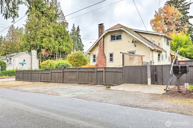 1934 NE Northgate Way, Seattle, WA 98125 - view of property exterior with a chimney and fence