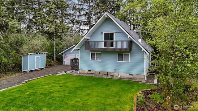 473 Mt Olympus Ave SE, Ocean Shores, WA 98569 - back of house featuring an outdoor structure, a balcony, a lawn, and a shed