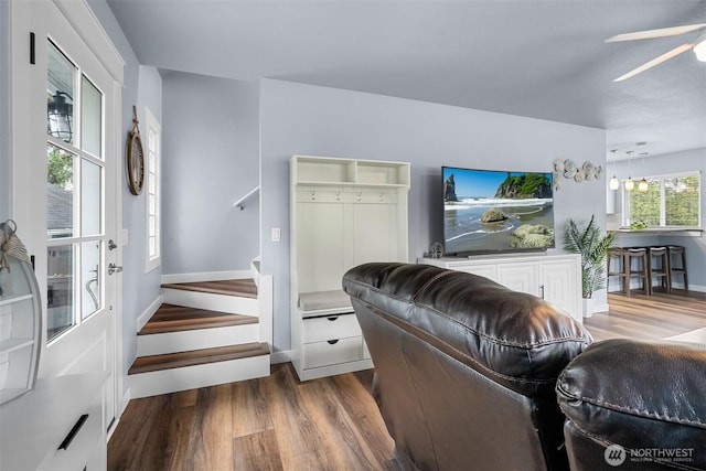 473 Mt Olympus Ave SE, Ocean Shores, WA 98569 - living area featuring wood finished floors, a ceiling fan, baseboards, and stairs