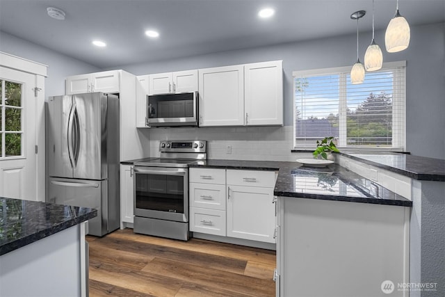 473 Mt Olympus Ave SE, Ocean Shores, WA 98569 - kitchen featuring appliances with stainless steel finishes, white cabinets, recessed lighting, pendant lighting, and dark wood-type flooring