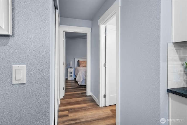 473 Mt Olympus Ave SE, Ocean Shores, WA 98569 - corridor featuring a textured wall and wood finished floors