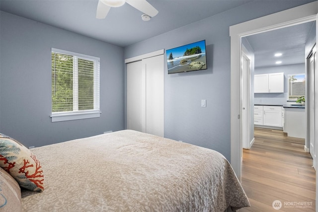 473 Mt Olympus Ave SE, Ocean Shores, WA 98569 - bedroom with wood finished floors, a closet, and a ceiling fan