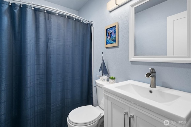 473 Mt Olympus Ave SE, Ocean Shores, WA 98569 - bathroom with toilet, a textured wall, vanity, and a shower with shower curtain