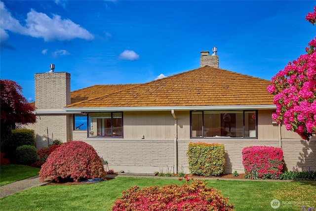12747 9th Ave NW, Seattle, WA 98177 - back of property with a chimney, brick siding, and a lawn