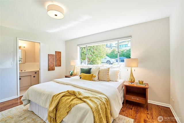 12747 9th Ave NW, Seattle, WA 98177 - bedroom featuring wood finished floors, baseboards, and ensuite bathroom