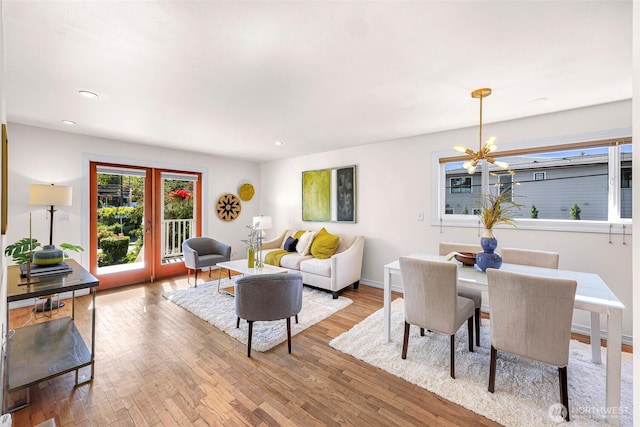 7503 24th Ave NE, Seattle, WA 98115 - living area featuring wood finished floors, a chandelier, recessed lighting, and baseboards