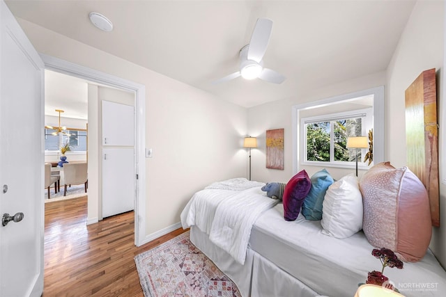 7503 24th Ave NE, Seattle, WA 98115 - bedroom with light wood finished floors, baseboards, and ceiling fan