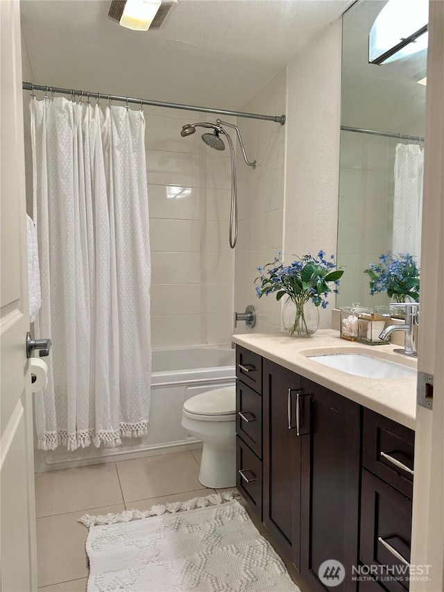 11054 NE 33rd Pl Unit B1, Bellevue, WA 98004 - full bathroom featuring tile patterned floors, toilet, shower / bathtub combination with curtain, vanity, and a textured wall