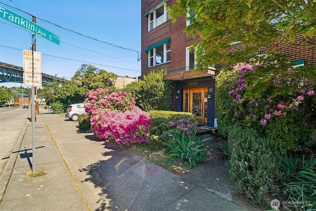 entrance to property featuring brick siding