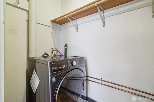 clothes washing area featuring washer / clothes dryer
