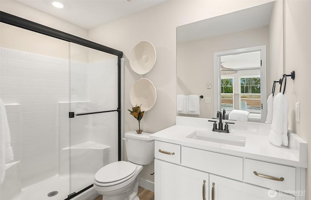 full bath with toilet, a stall shower, ensuite bath, vanity, and recessed lighting