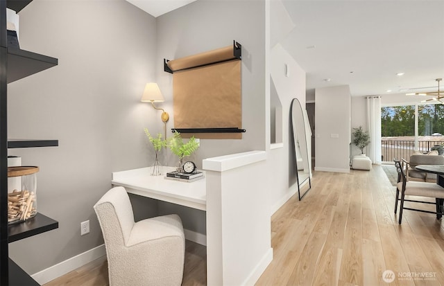 hallway with baseboards, stairway, light wood finished floors, and recessed lighting