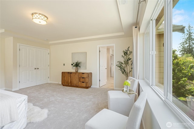 bedroom with light colored carpet and baseboards