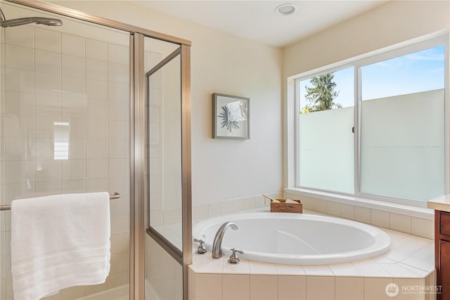 bathroom featuring a bath, a stall shower, and recessed lighting