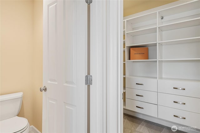 bathroom featuring toilet and baseboards