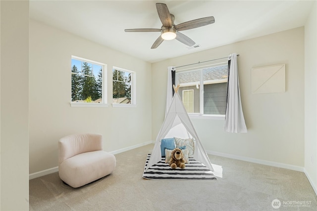 recreation room featuring carpet floors, baseboards, and ceiling fan