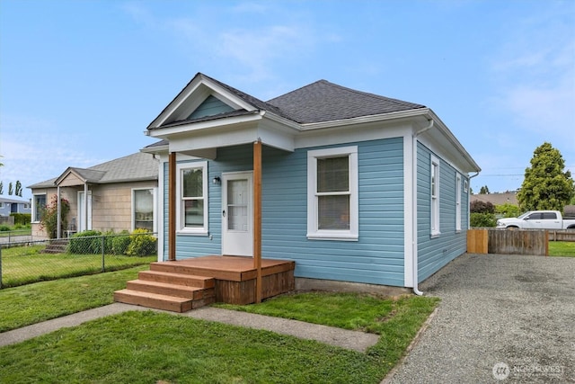 shotgun-style home with a shingled roof