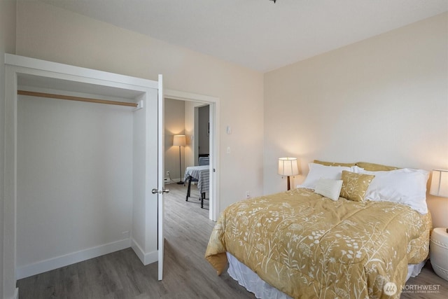 bedroom featuring wood finished floors and baseboards