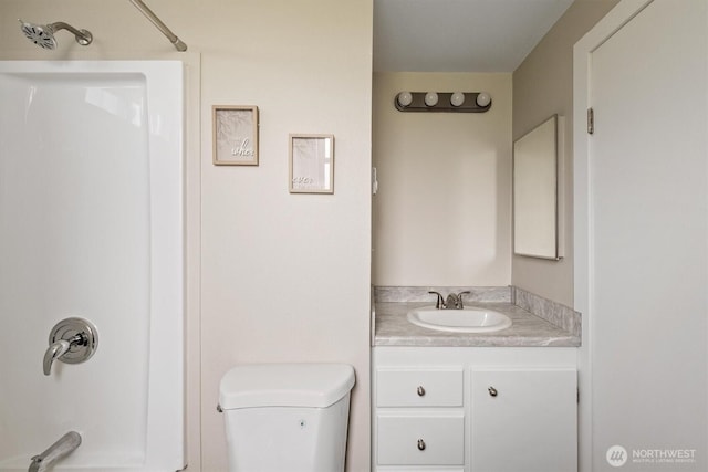 bathroom with vanity, toilet, and shower / tub combination